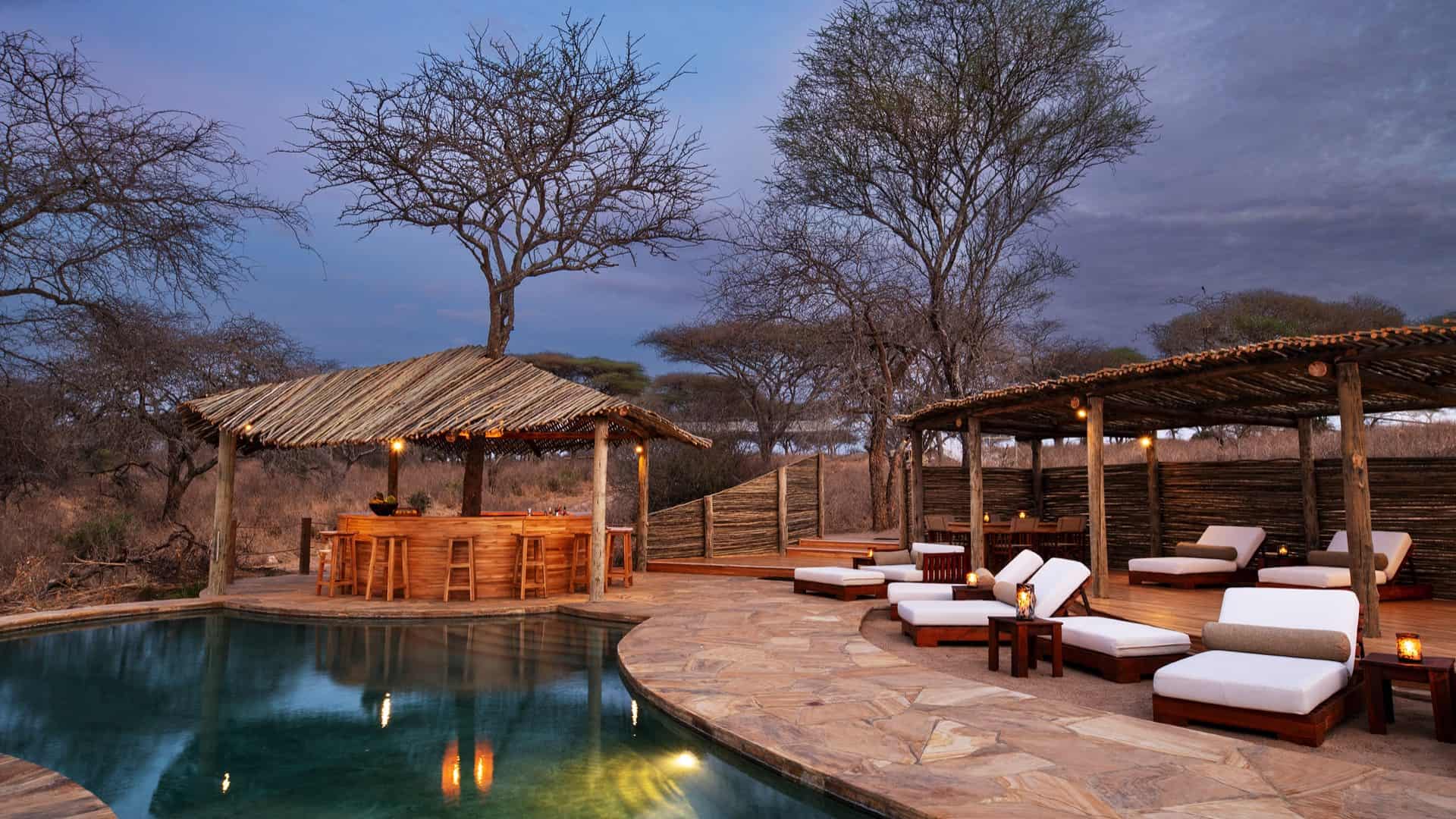 Oliver's Camp pool and bar at sunset